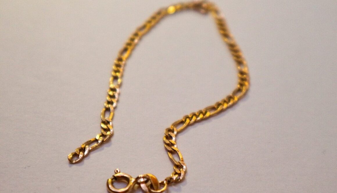 a gold chain with a letter on it