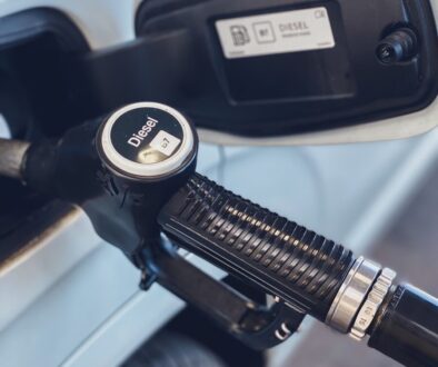 a close up of a gas pump with a car in the background