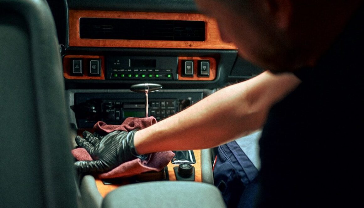 Mechanic working on car interior dashboard