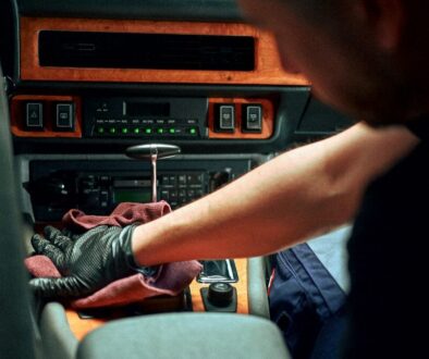 Mechanic working on car interior dashboard