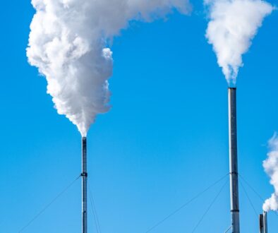 a smokestack emits from the top of a building