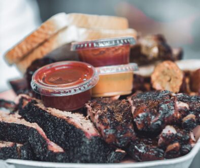 brown and white plastic container on black and brown chocolate cake