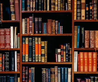 assorted-title of books piled in the shelves
