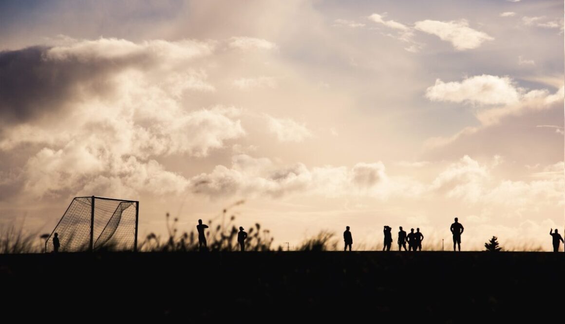 people gathering at soccer field