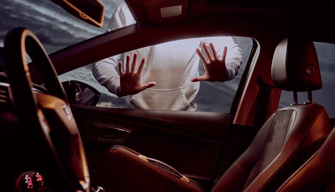 man in white long sleeve shirt driving car