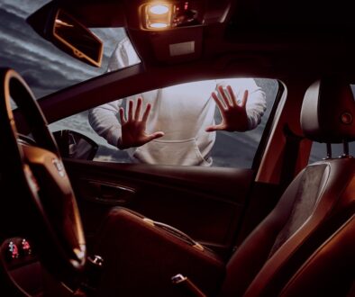 man in white long sleeve shirt driving car