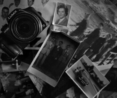 A camera rests amidst old photographs.