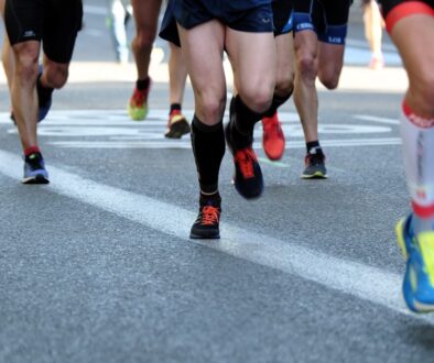 people running on gray asphalt road during daytime