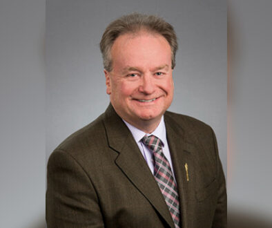 Man with a suit smiling for a picture