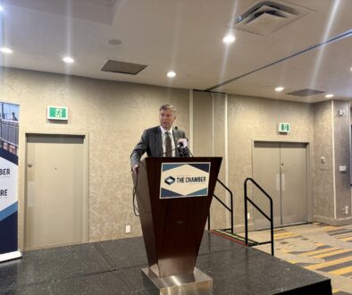 Man in a suit standing in front of a podium