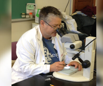 Scientist looking through a microscope