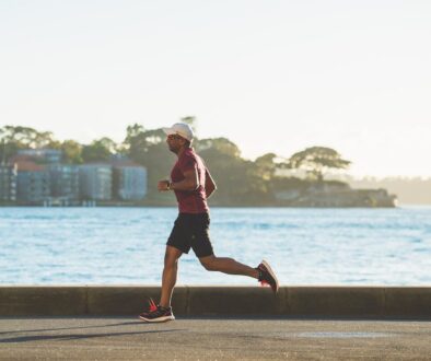 man running near sea during daytime