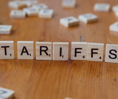 A wooden block spelling tarifs on a table