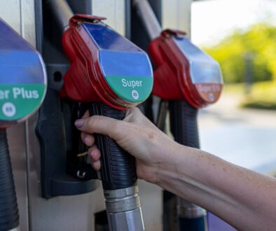 a person's hand is holding a gas pump
