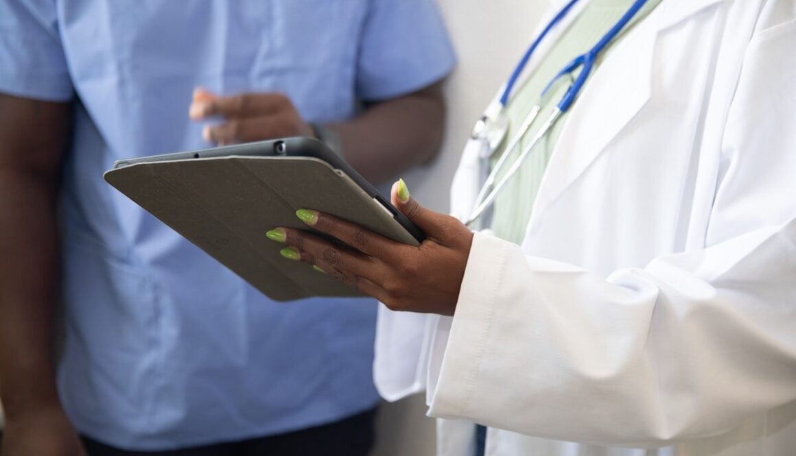 a doctor showing a patient something on the tablet