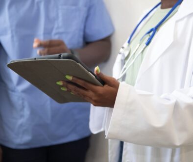 a doctor showing a patient something on the tablet