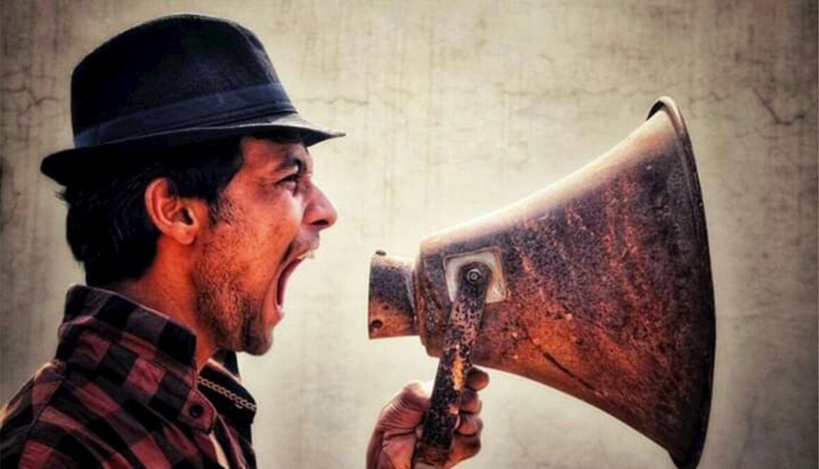 A man with a hat and a megaphone
