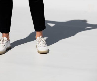 person in black pants and white and brown nike sneakers