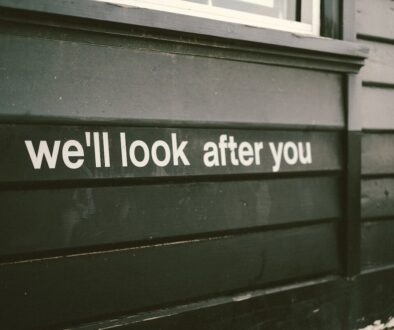 a sign on the side of a building that says we'll look after you