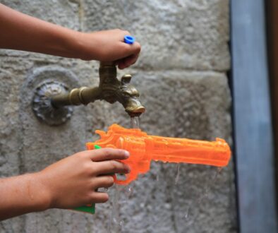 a person holding a water gun in their hand