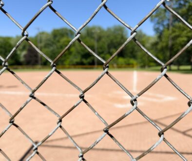 A baseball field through a chain link fence