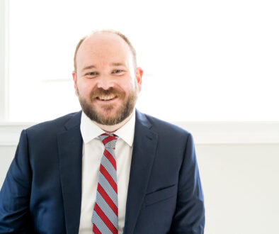 Businessman with blue suit smiling for a picture
