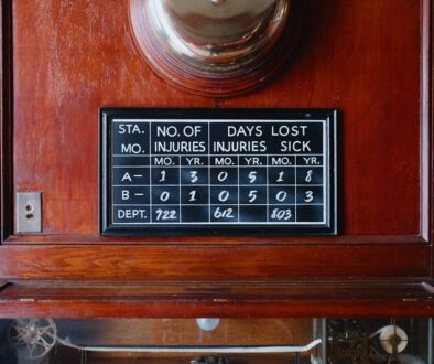 Vintage safety sign showing injury statistics on a wooden wall.