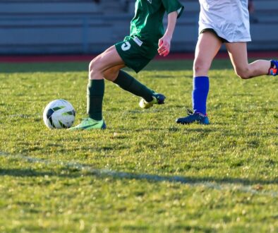 a couple of kids playing a game of soccer